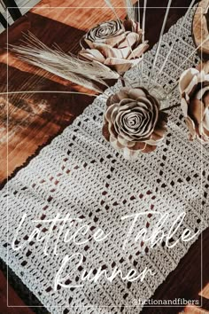 a crocheted table runner with flowers on it