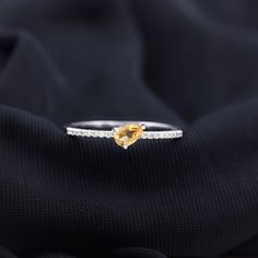 Product Details Make a profound statement of love with this exquisite Solitaire Ring designed for women. It is the ideal gift to express your affection. This ring showcases a stunning 5X7 MM Pear Cut Citrine, slantly placed in graceful Prong Setting, and is further embellished by glistening Round Shape Diamond gemstones. Let this be your heartfelt surprise to your beloved this season, a symbol of your deep and enduring love. Product Information SKU SHP-RINGS122041930 Width 4.5 mm Height 3.38 mm Fine Citrine Jewelry For Promise, Brilliant Cut Pear-shaped Rings For Gift, Exquisite Pear-shaped Diamond Ring Gift, Citrine Birthstone Promise Ring In Fine Jewelry, Fine Jewelry Citrine Birthstone Promise Ring, Promise Jewelry With Citrine In Prong Setting, Elegant Citrine Crystal Ring With Gemstone, Elegant Yellow Topaz Promise Ring, Elegant Citrine Crystal Ring