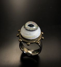 Hazel eye with swirls of rainbow Dichro amongst the white glass! The bezel is bronze, in the ring band is wide and made of Stainless steel! Of course I did the glass and had the bronze casted! Size Bronze bezel 1 inch wide 1/8 tall Eye 5/8 wide. 1/2 inch tall Ring band size 9 1/4 wide Handmade Mystical Iridescent Ring, Handmade Iridescent Mystical Ring, Mystical Handmade Iridescent Ring, Handmade Iridescent Jewelry For Collectors, Handmade Iridescent Collectible Jewelry, Unique Eye-shaped Jewelry For Gifts, Handmade Glass Jewelry For Collectors, Unique Glass Jewelry For Wedding, Artsy White Round Jewelry