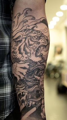 a man with a dragon tattoo on his arm