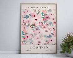 a flower market poster on the wall next to a potted plant