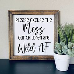 a sign that says please excuse the mess our children are wild at