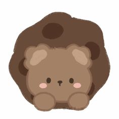 a brown teddy bear sitting in front of a rock