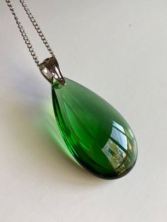 "A beautiful 50mm Emerald green smooth coated glass teardrop pendant necklace. Stainless steel chain and a silver over brass bail. Available in 20\", 30\". Hand made jewelry. All purchase will arrive in gift boxes. Thanks for stopping by!" Green Glass Pendant Necklace, Iridescent Necklace, Woman Jewelry, Glass Pendant Necklace, Teardrop Necklace, Teardrop Pendant, Hand Made Jewelry, Steel Chain, Necklace Silver