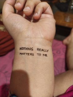 a woman's arm with the words nothing really matters to me written on it