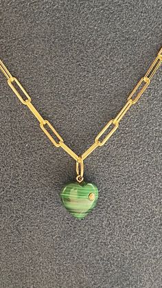 3/4 inch diamond/malachite disc charm  Celebrity style One inch - Not too big , not too small perfect with chains and layers Sterling with gold plate Bring in good karma and prosperity into your life with this Malachite Heart Pendant. This pendant features diamonds set in sterling with 14KT Yellow Gold. Luxury Green Necklace With Heart Charm, Emerald Heart Charm Jewelry, Emerald Jewelry With Heart Charm As Gift, Green 14k Gold Heart Jewelry, Green Heart-shaped 14k Gold Jewelry, Green 14k Gold Heart Pendant Necklace, Green Heart-shaped Charms Jewelry, Green Heart Charm Round Jewelry, Green Heart Charm Jewelry