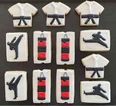 decorated cookies in the shape of t - shirts and uniforms are arranged on a tray