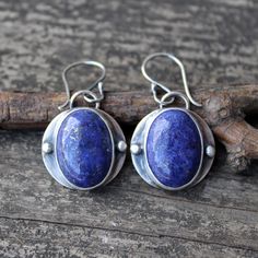 🌟PLEASE READ the following description before making your purchase.  Note measurements and size reference photos. Lapis lazuli sterling silver dangle earrings 13x18mm lapis lazuli is set in pure silver on a 19mm sterling disc dangling from comfortable argentium silver (hypoallergenic) ear wires. Medium weight dangles measuring a touch over 1 1/4" long Rustic Blue Sterling Silver Jewelry, Rustic Silver Oval Jewelry, Rustic Silver Jewelry With Natural Stones, Handmade Rustic Oval Jewelry, Artisan Sterling Silver Earrings With Natural Stones, Rustic Sterling Silver Dangle Jewelry, Rustic Hand Forged Sterling Silver Jewelry, Rustic Sterling Silver Dangle Earrings, Rustic Sterling Silver Earrings