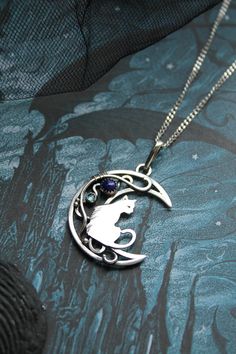 ITEM DESCRIPTION: The size of this moon pendant H 4 cm x W 3 cm. Weight - 4g. You can buy this necklace with a chain or without. Jewelry will come to you in a gift box - ready for gift giving. I made this moon phases necklace of sterling silver, Lapis lazuli, and topaz London. It looks like a real magic art. The handmade silver pendant with the cat will be a great gift for cat lovers. The parcel will be sent during 1-2 days after payment. Delivery usually takes 10-21 days. But in the period from Collectible Moon Charm Pendant Necklace, Collectible Round Pendant With Moon Charm, Cat Design Round Pendant Jewelry Gift, Cat Design Pendant Jewelry, Ursula Jewelry, Random Jewelry, Wire Animals, Cat And Moon, Moon Fashion