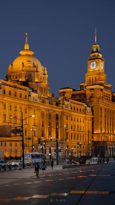 a large building with a clock tower at night