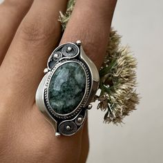 Handmade sterling silver ring with natural moss agate stone. Green gemstone ring in filigree technique and vintage style. Artisan jewelry made in Armenia by the Shahinian family. The ring`s band is adjustable and comfortable both to wear and give as a gift to those who don`t know the exact size of the finger. This ring is the perfect gift idea also for the ones who love unique, modern, and high-quality jewelry. ⦿We can also make matching earrings, pendants, and bracelets. For more details, just Oval Moss Agate Gemstone Ring, Bohemian Agate Ring With Large Stone, Jade Ring With Natural Stones, Jade Jewelry With Natural Stones, Handmade Bohemian Emerald Open Ring, Bohemian Emerald Ring With Natural Stones, Bohemian Handmade Open Emerald Ring, Elegant Moss Agate Ring With Natural Stones, Handmade Oval Moss Agate Ring