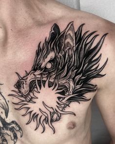 a man's chest with a dragon tattoo on it