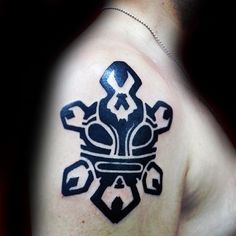 a man with a tattoo on his shoulder that has an image of a crown in the middle