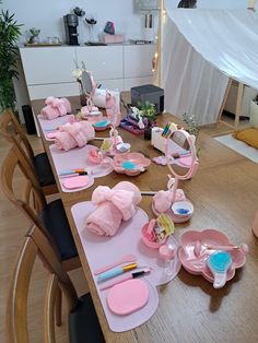 the table is set up with pink items for children's birthdays and baby showering