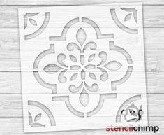 the stencil is cut out to look like an ornate design on a wooden surface