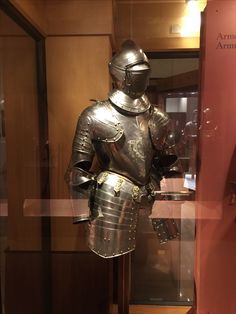 a suit of armor on display in a glass case