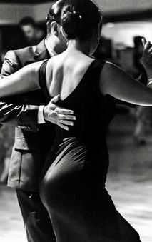 a man and woman are dancing together on the dance floor in black and white photo