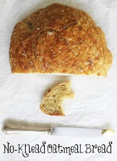 a loaf of bread sitting next to a knife