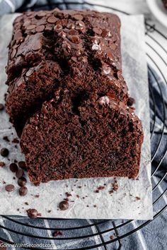 a loaf of chocolate cake sitting on top of a wire rack