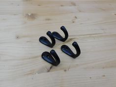 three black handles on a wooden surface