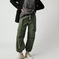 Style No. 79330031; Color Code: 037 Cool In Cargo, These Sporty Pants Are A True Timeless Staple. Fit: Mid-Rise, Tapered Fit And Classic Cargo Silhouette Features: Smocked Waistband With Drawstring Detail, Cargo Pockets Throughout, Banded Hemlines, Sleek Nylon Fabrication Why We <3 It: Just As Effortless As They Are Versatile, These Pants Have Endless Ways To Wear. Care/Import Machine Wash Cold Import Measurements For Size Small Waist: 30.5 In Hips: 42 In Rise: 12.25 In Inseam: 27.25 In 53% Nylo Fall Utility Parachute Pants With Tapered Leg, Casual Winter Cargo Pants In Nylon, Casual Winter Nylon Cargo Pants, Winter Casual Nylon Cargo Pants, Fall Nylon Bottoms With Cargo Pockets, Fall Utility Parachute Trousers, Winter Nylon Bottoms With Side Pockets, Winter Utility Straight Leg Parachute Pants, Winter Utility Parachute Pants With Straight Leg