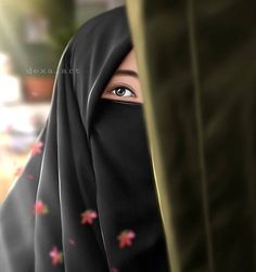 a woman wearing a black hijab with pink flowers on it