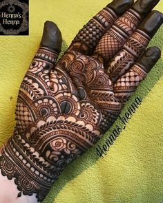 the hand is decorated with henna designs on it's fingers and hands, which are