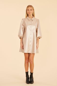 Our Metallic Faux Leather Puff Sleeve Dress brings just the right amount of shine to your wardrobe. Its soft golden shade offers an eye-catching metallic sheen, while maintaining a subtle, elegant vibe. Complete with a basic collar and three-quarter puff sleeves, this dress is perfect for making a bold statement at your next evening out or special event. Faux leather Three-quarter puff sleeves Buttoned front Available in Pale Gold Dry clean Style: 74996 Chic Long Sleeve Faux Leather Dress, Chic Cream Puff Sleeve Mini Dress, Faux Leather Puff Sleeve Dress, Spring Metallic Long Sleeve Mini Dress, Feaux Leather Dress, Kimono Outerwear, Cap Fashion, Felt Cowboy Hats, Concert Fashion