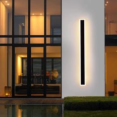 a modern house with an illuminated number one on the wall