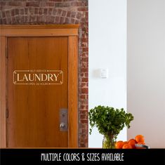 a wooden door sitting next to a vase filled with oranges