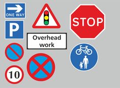 various traffic signs and stickers on a gray background including stop, overhead work, no parking