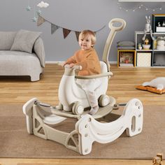 a small child sitting in a baby walker