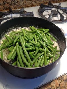 green beans are cooking in a pan on the stove