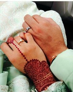 two people with wedding rings on their hands