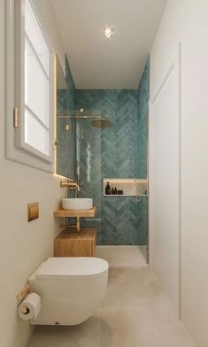 a bathroom with a white toilet sitting next to a sink under a window in front of a walk in shower