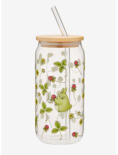 a glass jar with strawberries and cats on it