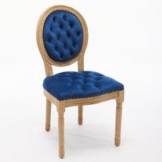 a wooden chair with blue velvet upholstered on the back and seat, against a white background