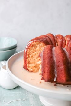 a bundt cake on a plate with one slice cut out and ready to be eaten