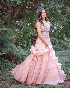 A frilled pink skirt paired with a unique scallop-edge blouse. It is paired with a ruffle dupatta. DELIVERY TIME Please allow 8-12 weeks for your outfit to arrive. FABRIC DETAILSCrepe. Professional cleaning only. Anarkali Sets With Ruffles In Georgette, Designer Georgette Sharara With Ruffles, Anarkali Floor-length Sets With Ruffles, Anarkali Dress With Ruffles And Peplum Design, Anarkali Dresses With Ruffles And Peplum, Floor-length Georgette Sets With Ruffles, Floor-length Ruffled Sets For Festive Occasions, Floor-length Sets With Ruffles In Georgette, Festive Floor-length Ruffled Sets