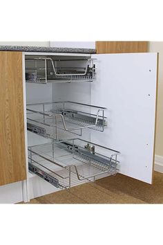 an open cabinet with shelves and baskets in the bottom drawer for extra storage space on either side