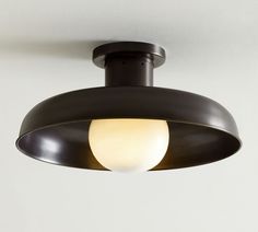 a black ceiling light with a white ball on the top and one yellow light at the bottom