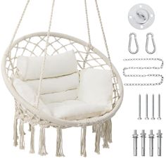 a white hanging chair with pillows and hooks