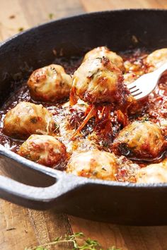 a pan filled with meatballs covered in sauce