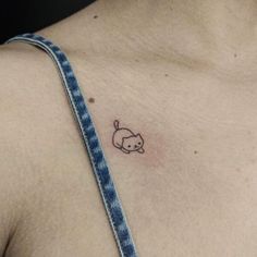 a small tattoo on the chest of a man's left shoulder and chest area