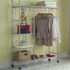 an iron rack with clothes and shoes on it