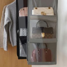 the purses and handbags are hanging on the wall next to the coat rack