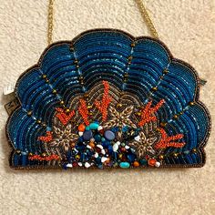 a blue beaded purse with orange and white beads