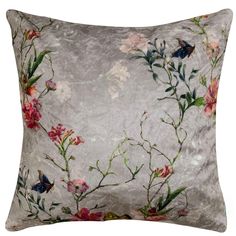 an embroidered pillow with flowers and butterflies on the front, in grey velvete fabric