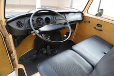 the interior of an old car with black leather seats and wood paneling on it