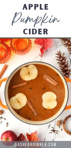 an apple pumpkin cider with apples and cinnamons in it, surrounded by fall leaves